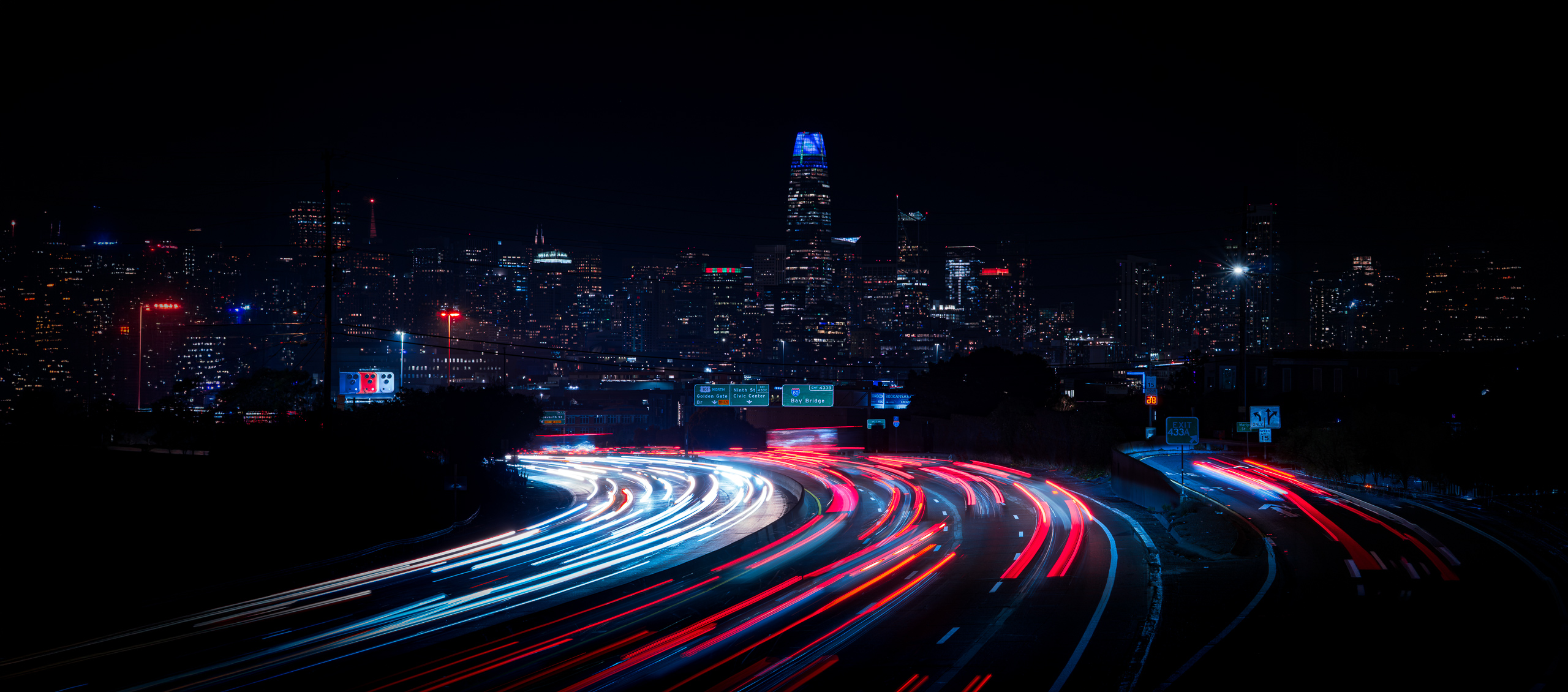 San Francisco skyline with freeway light trails at night