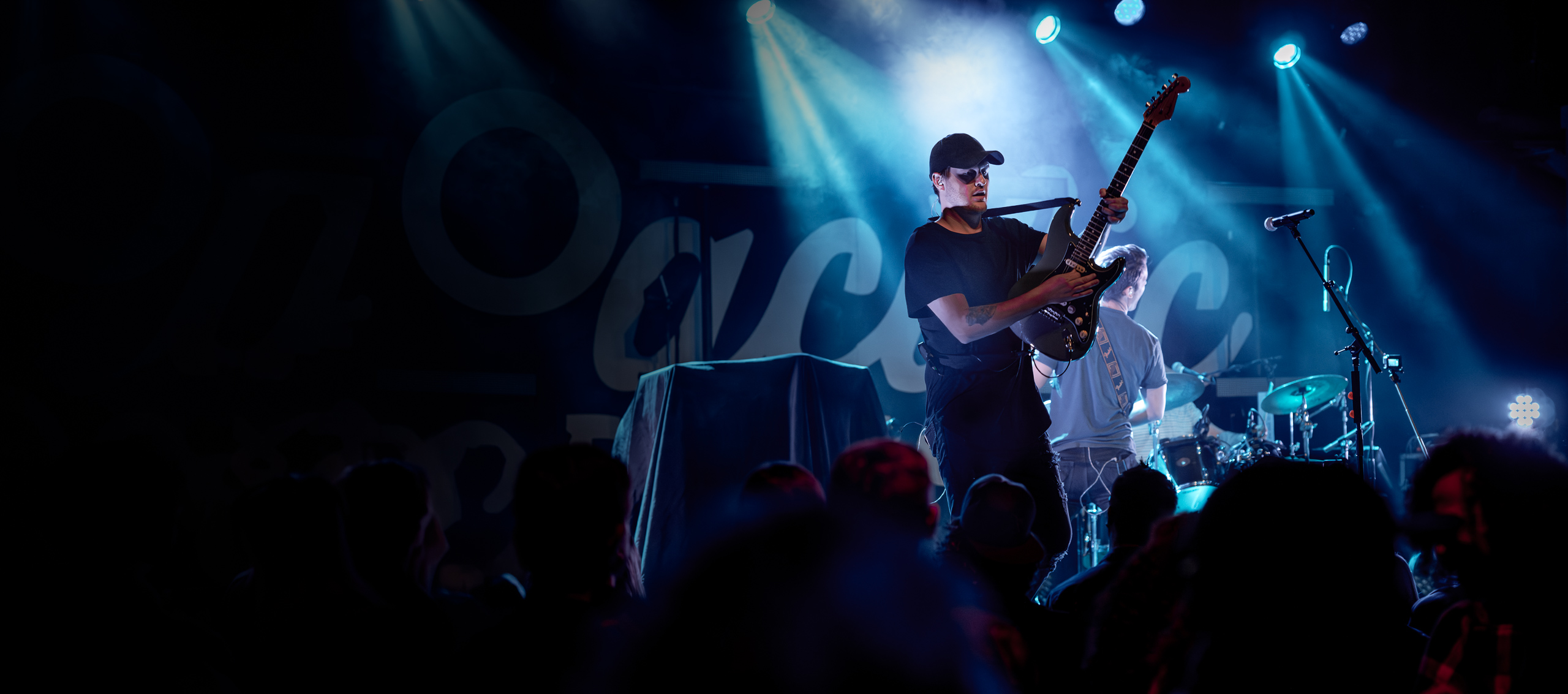 Concert guitarist under blue stage lights